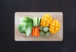 cutting board of healing fruits and veggies